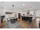 Open kitchen and dining area featuring a large island, sleek countertops, and modern appliances at 3638 Silvery Way, Powder Springs, GA 30127