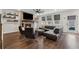 Contemporary living room featuring a brick fireplace, a ceiling fan, and ample natural light at 3638 Silvery Way, Powder Springs, GA 30127