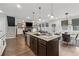 Open-concept living room and kitchen with a fireplace and access to the backyard at 3638 Silvery Way, Powder Springs, GA 30127