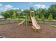 Community playground featuring slides and climbing structures with a mulch ground cover for safety at 3638 Silvery Way, Powder Springs, GA 30127