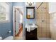 Stylish bathroom featuring tiled shower, modern vanity, and bright natural light at 690 Manor Ridge Sw Dr, Mableton, GA 30126