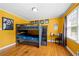 Bright bedroom with a bunk bed, a study area, and hardwood floors at 690 Manor Ridge Sw Dr, Mableton, GA 30126
