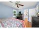 Bedroom with hardwood floors, ceiling fan, and a view into an ensuite bathroom at 690 Manor Ridge Sw Dr, Mableton, GA 30126