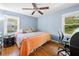 Cozy bedroom with hardwood floors, ceiling fan, and windows with natural light at 690 Manor Ridge Sw Dr, Mableton, GA 30126