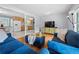 Cozy living room with hardwood floors, plush blue seating, and view into the kitchen at 690 Manor Ridge Sw Dr, Mableton, GA 30126