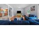 Bright living room with hardwood floors, blue sofas, and open view to the kitchen at 690 Manor Ridge Sw Dr, Mableton, GA 30126