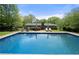Enjoy a spacious in-ground pool perfect for summer fun, with a grassy backyard and landscaping at 690 Manor Ridge Sw Dr, Mableton, GA 30126