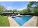 In-ground pool surrounded by a concrete patio, backyard landscaping, and seating at 690 Manor Ridge Sw Dr, Mableton, GA 30126