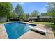 Backyard pool featuring a diving board and surrounding patio, perfect for outdoor enjoyment at 690 Manor Ridge Sw Dr, Mableton, GA 30126