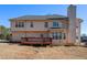 Large backyard with wood deck and siding on back of two-story house at 104 Lumby Ln, Stockbridge, GA 30281