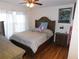 Cozy bedroom features hardwood floors, ceiling fan, and warm natural light from the large window at 104 Lumby Ln, Stockbridge, GA 30281