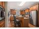 Traditional kitchen features wooden cabinets, stainless steel appliances, and granite countertops with an island and seating at 104 Lumby Ln, Stockbridge, GA 30281