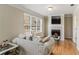 Cozy living room with fireplace, hardwood floors, and large window with lots of natural light at 104 Lumby Ln, Stockbridge, GA 30281