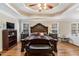 Spacious main bedroom boasts hardwood floors, tray ceilings, fireplace, and an adjacent seating area at 104 Lumby Ln, Stockbridge, GA 30281