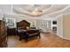 Spacious main bedroom boasts hardwood floors, tray ceilings, fireplace, and an adjacent seating area at 104 Lumby Ln, Stockbridge, GA 30281