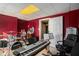 Spacious music room featuring a full drum set, keyboard and red walls at 104 Lumby Ln, Stockbridge, GA 30281
