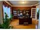 Home office featuring hardwood floors, and built-in bookshelves, creating a comfortable work environment at 104 Lumby Ln, Stockbridge, GA 30281