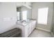 Well-lit bathroom featuring double sinks, granite countertops, and a large mirror at 166 Fender Walk, Marietta, GA 30060