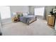 Sun-filled bedroom featuring neutral walls, carpet, and a comfortable queen-sized bed, side table and dresser at 166 Fender Walk, Marietta, GA 30060