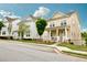 Street view of new construction townhomes with welcoming front porches and manicured lawns on a sunny day at 166 Fender Walk, Marietta, GA 30060