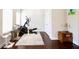 Home gym features an elliptical machine, a cat tree, wood floors and natural light from the large window at 166 Fender Walk, Marietta, GA 30060