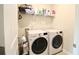 Convenient laundry room with modern washer and dryer, shelving, and ample storage space at 166 Fender Walk, Marietta, GA 30060