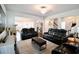 Spacious living room is fitted with leather furniture, a decorative rug, and an open floorplan at 166 Fender Walk, Marietta, GA 30060