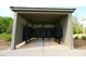 Community mailboxes are sheltered by a covered structure with a latticework design and landscaping at 166 Fender Walk, Marietta, GA 30060