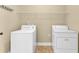Bright laundry room featuring a washer, dryer, and shelving for storage at 2603 Dayview Ln, Atlanta, GA 30331