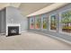 Living room with large windows, carpeted floors, and a fireplace at 2603 Dayview Ln, Atlanta, GA 30331
