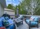 A partially shaded deck with seating, grill, and a view of the backyard at 305 Nobleman Way, Canton, GA 30114