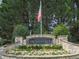 Community entrance featuring a stone sign and beautiful landscaping at 305 Nobleman Way, Canton, GA 30114