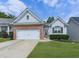 Charming home featuring a brick and siding facade with manicured landscaping at 305 Nobleman Way, Canton, GA 30114