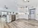 Open concept kitchen with stainless steel appliances and bright white cabinets at 305 Nobleman Way, Canton, GA 30114