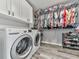 This laundry room includes a washer, dryer, storage, shelving, and plenty of room for clothing at 305 Nobleman Way, Canton, GA 30114