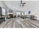 Spacious living room boasts a fireplace, ceiling fan and wood flooring at 305 Nobleman Way, Canton, GA 30114