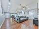 The living room has wood floors and a large gray sectional couch with plenty of light at 305 Nobleman Way, Canton, GA 30114