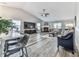 Bright living room featuring a fireplace, ceiling fan, and lots of natural light at 305 Nobleman Way, Canton, GA 30114