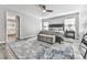 This main bedroom is spacious, with a ceiling fan, bench, large rug, and view into the main bathroom at 305 Nobleman Way, Canton, GA 30114