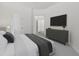 Modern bedroom featuring a television, dresser, and gray textured carpet at 3621 Vinings Slope Se # 3204, Atlanta, GA 30339