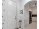 Bright entryway with a white door and an arched doorway to the kitchen at 3621 Vinings Slope Se # 3204, Atlanta, GA 30339