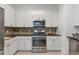 Well-equipped kitchen with stainless steel appliances, ample cabinet space, and tiled backsplash at 3621 Vinings Slope Se # 3204, Atlanta, GA 30339