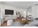 Open-concept living room with hardwood floors, a TV, a dining area, and a kitchen at 3621 Vinings Slope Se # 3204, Atlanta, GA 30339