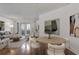 Bright living room features hardwood floors, neutral decor, and access to the outdoors through French doors at 3621 Vinings Slope Se # 3204, Atlanta, GA 30339