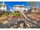 Backyard area with a patio fire pit, landscaping, and steps leading up to the house at 3634 Lost Oak Dr, Buford, GA 30519