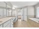 Bathroom with dual sink vanity and soaking tub with tile surround at 3634 Lost Oak Dr, Buford, GA 30519