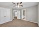 Bedroom with neutral walls, ceiling fan, closet doors and connected bathroom at 3634 Lost Oak Dr, Buford, GA 30519
