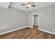 Bedroom featuring new wood-look flooring, fresh gray paint, and updated ceiling fan at 3634 Lost Oak Dr, Buford, GA 30519