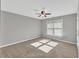 Bedroom with window, neutral walls, ceiling fan, and plush carpeting at 3634 Lost Oak Dr, Buford, GA 30519