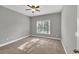 Cozy bedroom with neutral carpet offers a serene retreat with a ceiling fan for comfort at 3634 Lost Oak Dr, Buford, GA 30519